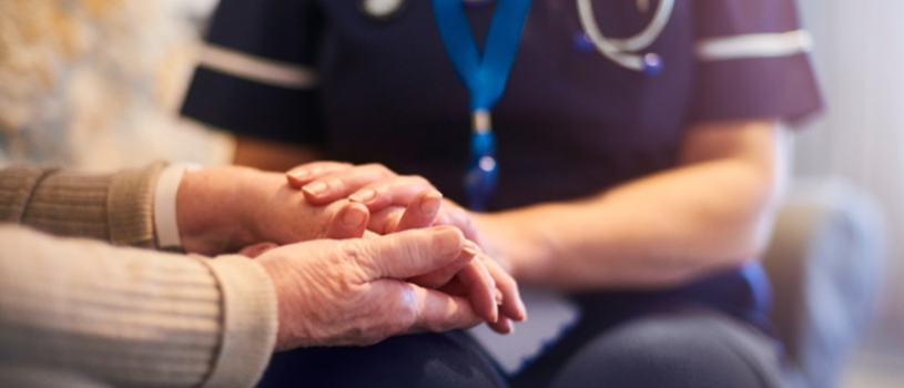Hands of an elderly person and nurse